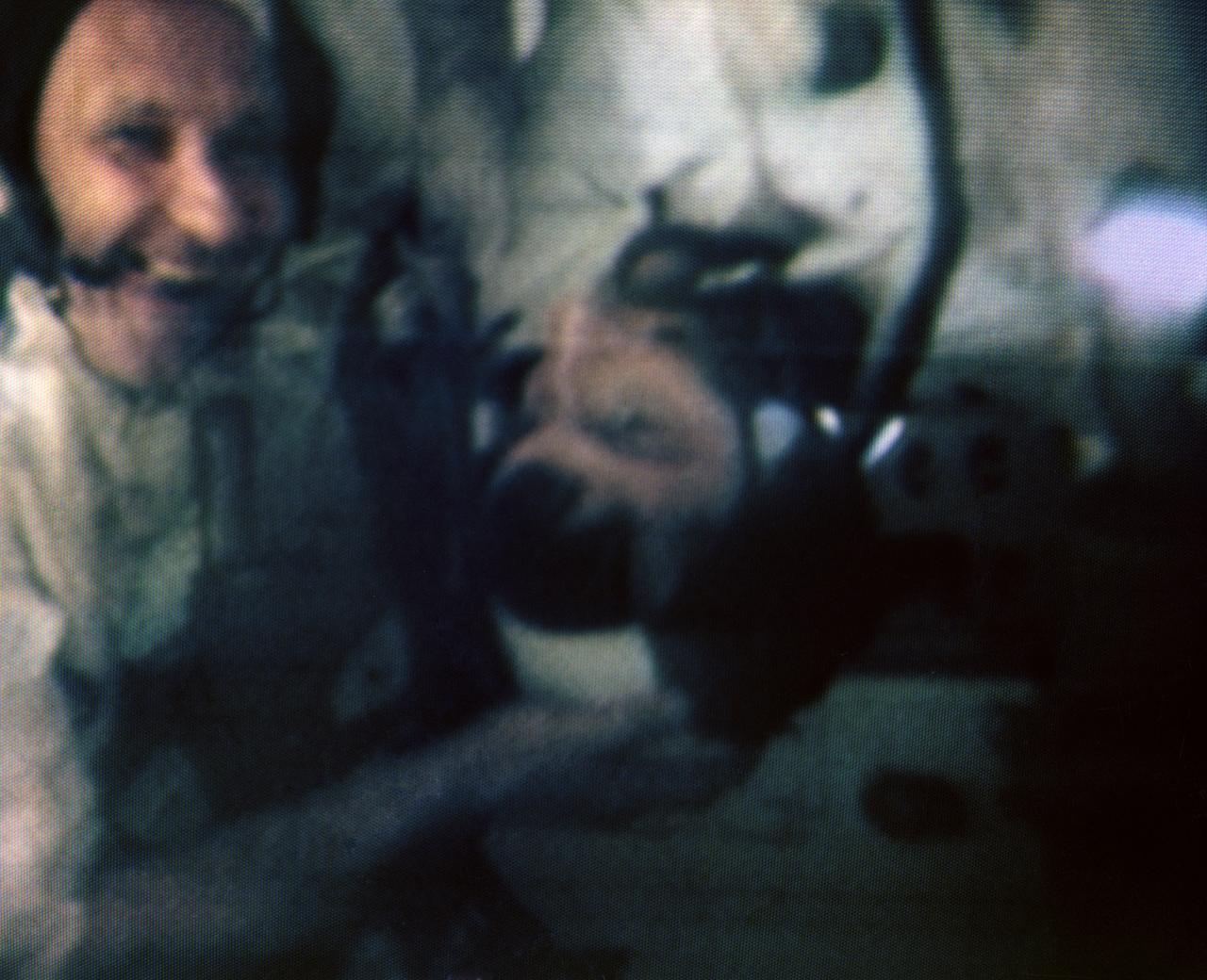 S69-34077 (19 May 1969) --- Astronaut Thomas P. Stafford (left) gives a graphic example of conditions in a weightless environment by literally holding astronaut John W. Young up by the head in this color reproduction taken from the fourth telecast made by the color television camera aboard the Apollo 10 spacecraft. When this picture was made the Apollo 10 spacecraft was about halfway to the moon, or approximately 112,000 nautical miles from Earth. Stafford is the Apollo 10 commander and Young is the command module pilot. Also, aboard Apollo 10 was astronaut Eugene A. Cernan, lunar module pilot.