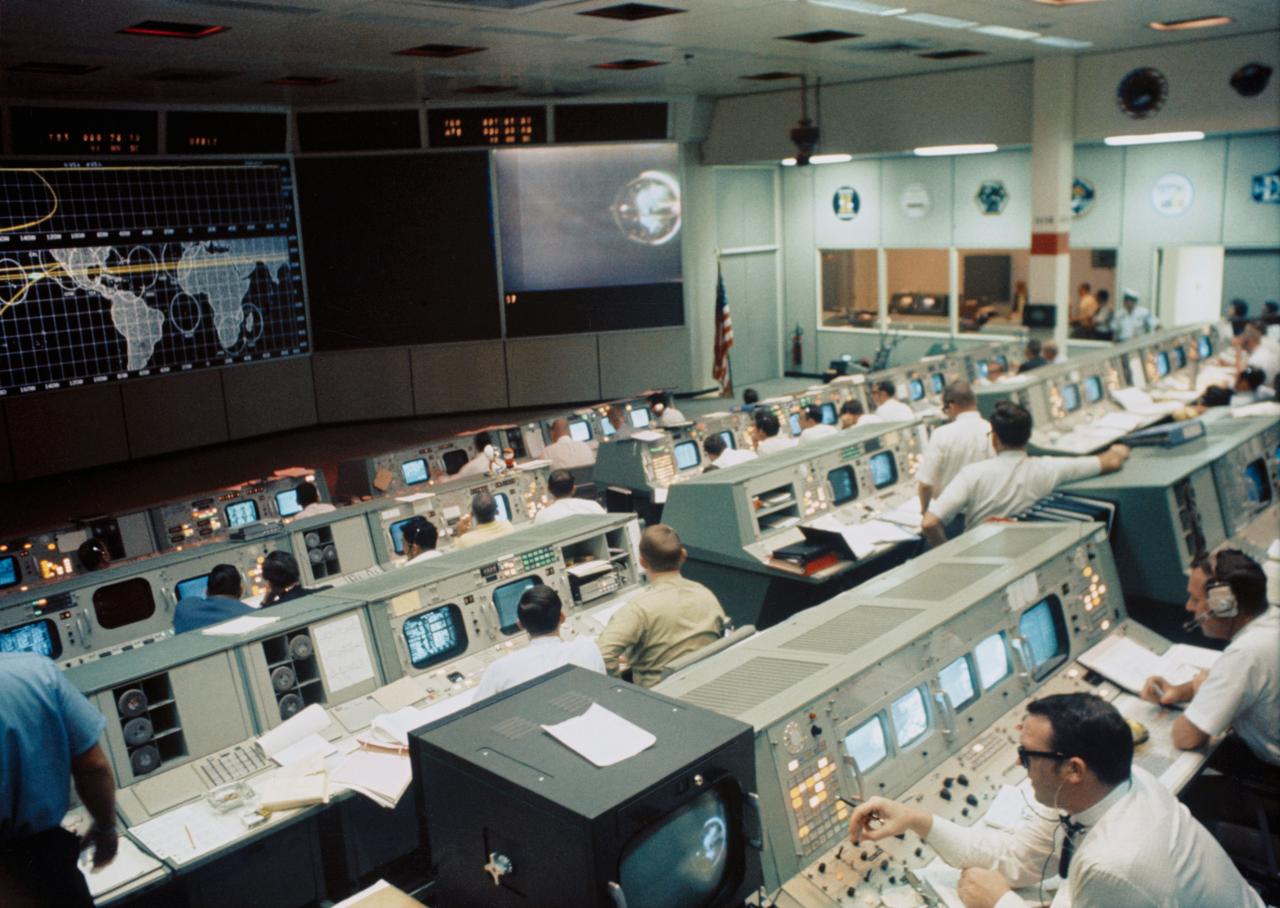 S69-34316 (18 May 1969) --- Overall view of the Mission Operations Control Room in the Mission Control Center, Building 30, on the first day of the Apollo 10 lunar orbit mission. A color television transmission was being received from Apollo 10. This picture was made following Command and Service Module/Lunar Module/Saturn IVB (CSM/LM-S-IVB) separation and prior to LM extraction from the S-IVB. The CSM were making the docking approach to the LM/S-IVB.