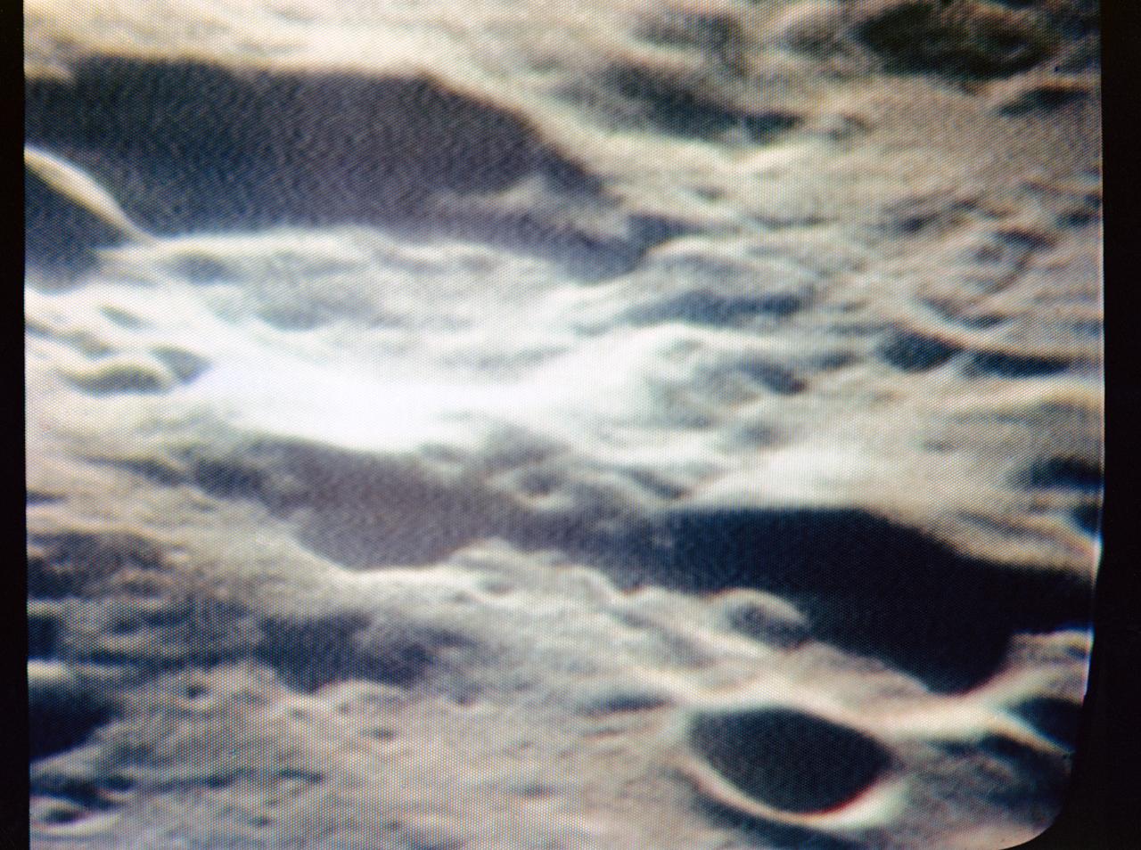 S69-34476 (21 May 1969) --- An oblique view of a group of craters just west of the Sea of Fertility (Mare Fecunditatis) on the lunar nearside is seen in this color reproduction taken from a telecast made by the color television aboard the Apollo 10 spacecraft as it orbited the moon. In this area are Gutenberg I, Capella A, Capella D, Capella E, and Capella M.