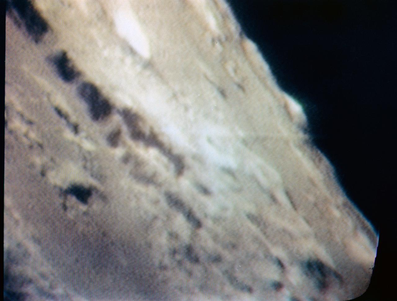 S69-34478 (21 May 1969) --- An oblique view of Barbara Mesa on the lunar nearside is seen in this color reproduction taken from a telecast made by the color television camera aboard the Apollo 10 spacecraft as it orbited the moon. This area is located generally east of Maskelyne crater on the southern edge of the Sea of Tranquility (Mare Tranquillitatis). Barbara Mesa is located at about 32 degrees 45 minutes east longitude and 1 degree 45 minutes north latitude.