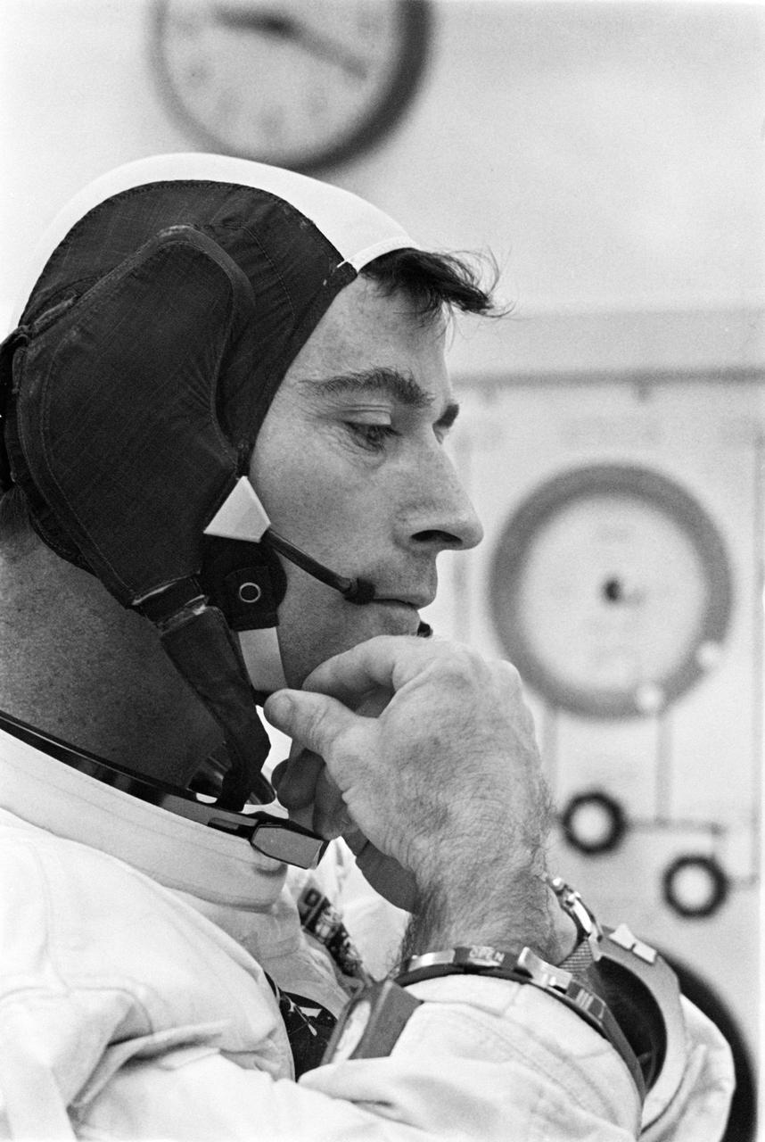 S69-34485 (18 May 1969) --- Astronaut John W. Young, Apollo 10 command module pilot, adjusts strap on his communications cap during suiting up operations for the lunar orbit mission. Minutes later astronauts Young; Thomas P. Stafford, commander; and Eugene A. Cernan, lunar module pilot, rode a transfer van from the Kennedy Space Center's Manned Spacecraft Operations Building over to Pad B, Launch Complex 39, where their spacecraft awaited them. Liftoff was at 12:49 p.m. (EDT), May 18, 1969.