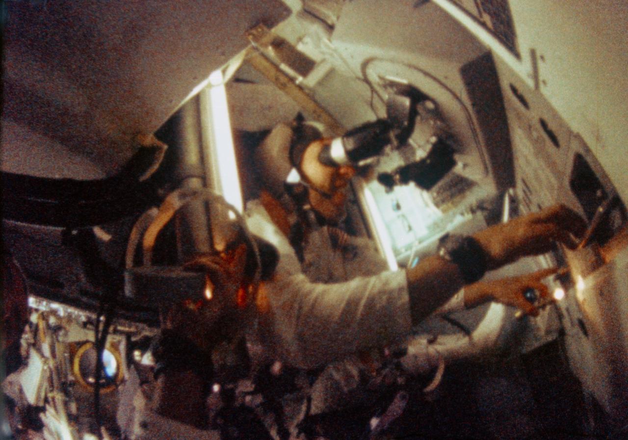 S69-35098 (21-27 Dec. 1968) --- Astronaut James A. Lovell Jr., Apollo 8 command module pilot, is seen at the Apollo 8 Spacecraft Command Module's Guidance and Navigation station during the Apollo 8 lunar orbit mission. This picture was taken from 16mm motion picture film.