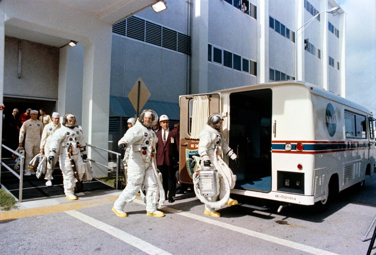 S69-35315 (18 May 1969) --- The Apollo 10 crew leaves the Kennedy Space Center's Manned Spacecraft Operations Building during the Apollo 10 prelaunch countdown. Leading is astronaut John W. Young, command module pilot, followed by astronauts Thomas P. Stafford, commander; and Eugene A. Cernan, lunar module pilot. The transfer van carried them over to Pad B, Launch Complex 39, where their spacecraft awaited them. Liftoff for the lunar orbit mission was at 12:49 p.m. (EDT), May 18, 1969.