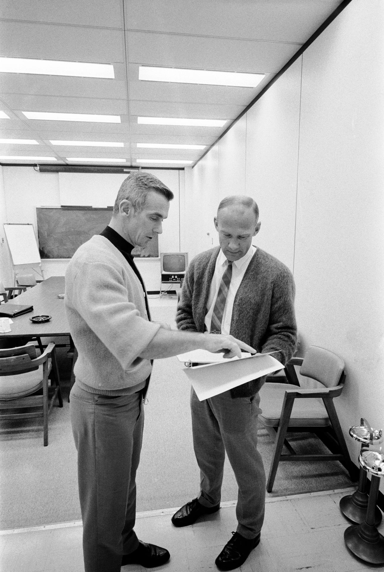 Gene Cernan works with Buzz Aldrin during an Apollo 10 debrief