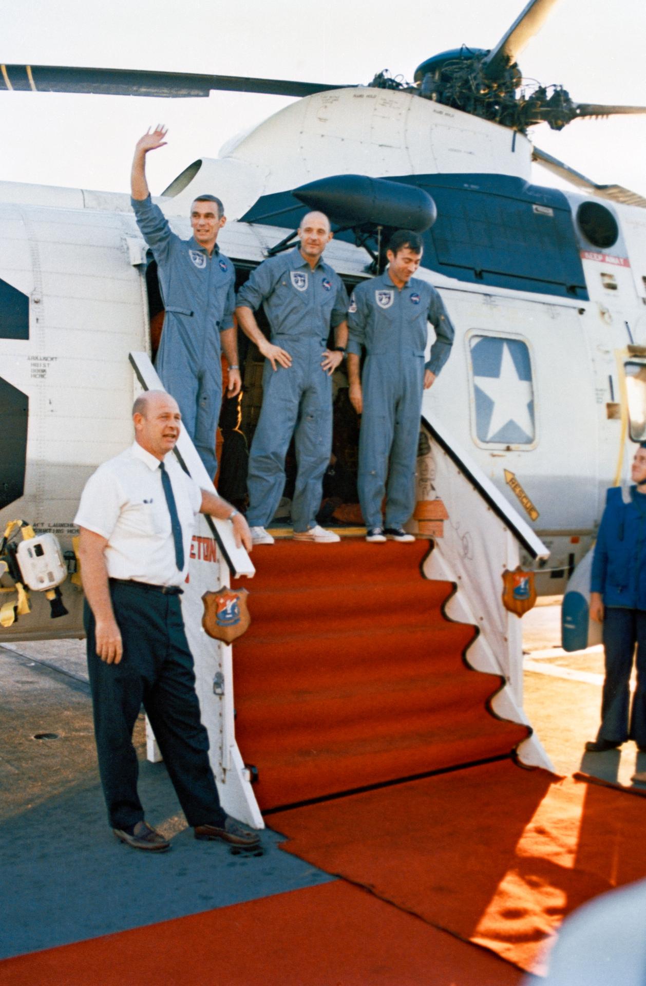 The Apollo 10 astronauts wave as they exit the recovery helicopter on the USS Princeton