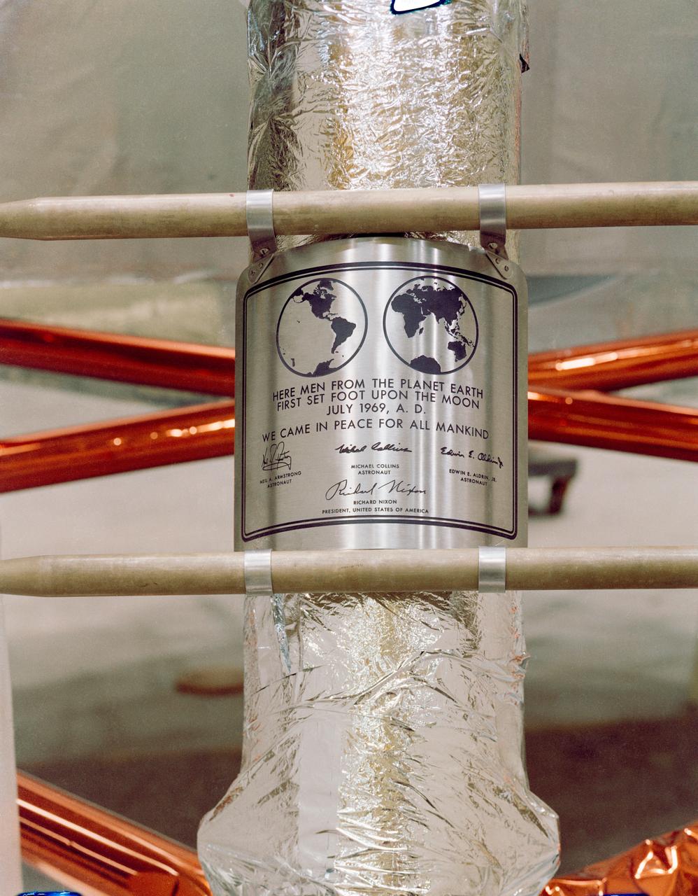 S69-38749 (July 1969) --- Close-up view of the plaque which the Apollo 11 astronauts will leave behind on the moon in commemoration of the historic event. The plaque is made of stainless steel measuring nine by seven and five-eighths inches, and one-sixteenth inch thick. The plaque will be attached to the ladder on the landing gear strut on the descent stage of the Apollo 11 Lunar Module (LM). Covering the plaque during flight will be a thin sheet of stainless steel which will be removed on the lunar surface.