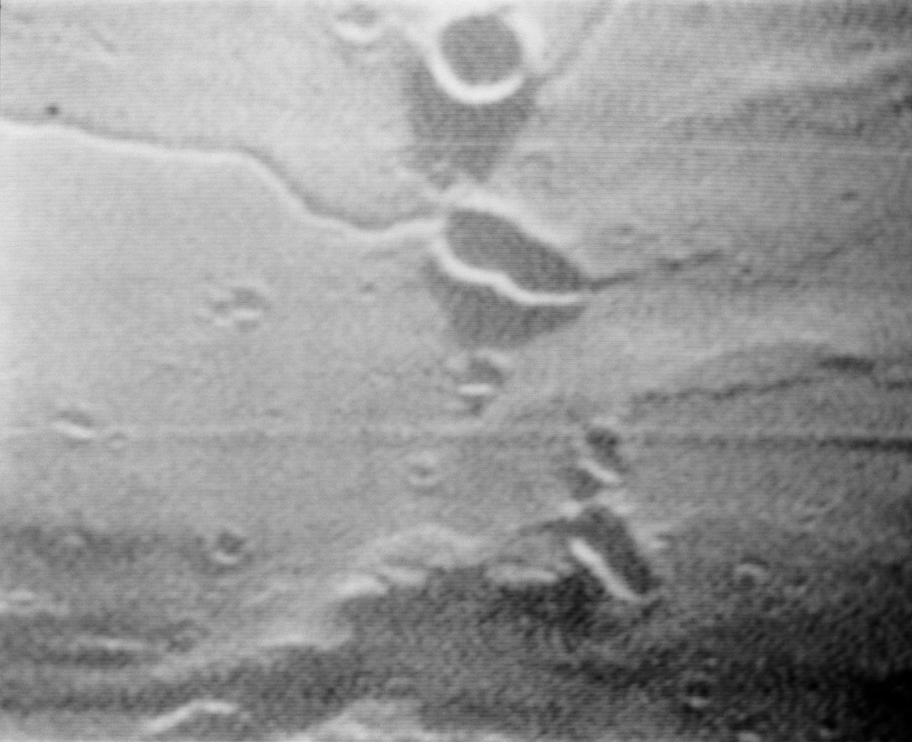 S69-39541 (19 July 1969) --- A near vertical view of Diamondback Rille is seen in this color reproduction taken from the fourth color television transmission from the Apollo 11 spacecraft, during its second revolution of the moon. The center of the picture is located at about 26.9 degrees east longitude and 1.2 degrees north latitude. This area is just east of the Apollo Landing Site 2. The crew of the Apollo 11 lunar landing mission is astronauts Neil A. Armstrong, commander; Michael Collins, command module pilot; and Edwin E. Aldrin Jr., lunar module pilot.