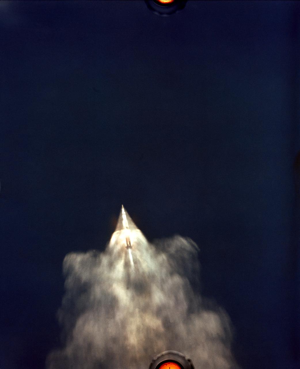 S69-39957 (16 July 1969) --- A 70mm Airborne Lightweight Optical Tracking System (ALOTS) took this picture. ALOTS tracking camera mounted on an Air Force EC-135 aircraft flying at about 40,000 feet altitude photographed this event in the early moments of the Apollo 11 launch. The 7.6 million-pound thrust Saturn V (S-1C) first stage boosts the space vehicle to an altitude of 36.3 nautical miles at 50.6 nautical miles downrange in 2 minutes 40.8 seconds. The S-1C stage separates at 2 minutes 41.6 seconds after liftoff. The crew of the Apollo 11 NASA's first lunar landing mission are astronauts Neil A. Armstrong, Michael Collins, and Edwin E. Aldrin Jr. The Apollo 11 launch was at 9:32 a.m. (EDT), July 16, 1969.