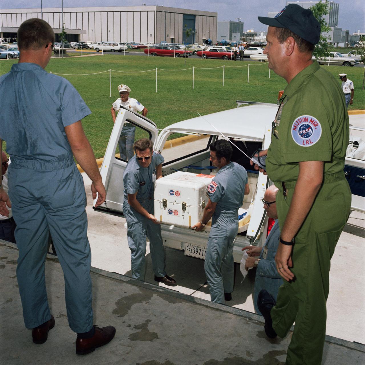 S69-39996 (25 July 1969) --- The first Apollo 11 sample return container, with lunar surface material inside, is unloaded at the Lunar Receiving Laboratory, Building 37, Manned Spacecraft Center (MSC). The rock box had arrived only minutes earlier at Ellington Air Force Base by air from the Pacific recovery area. The lunar samples were collected by astronauts Neil A. Armstrong and Edwin E. Aldrin Jr. during their lunar surface extravehicular activity.