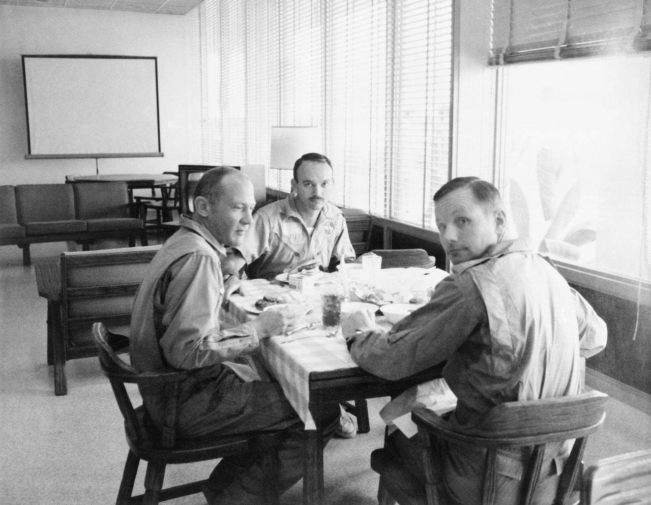 S69-40306 (30 July 1969) --- The crewmen of the historic Apollo 11 lunar landing mission are seen dining in the Crew Reception Area of the Lunar Receiving Laboratory, Building 37, Manned Spacecraft Center. Left to right, are astronauts Edwin E. Aldrin Jr., Michael Collins, and Neil A. Armstrong. They are continuing their postflight debriefings. The astronauts will be released from quarantine on Aug. 11, 1969.