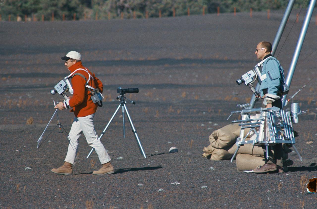 S69-55667 (10 Oct. 1969) --- Astronauts Charles Conrad Jr. and Alan L. Bean train for their upcoming Apollo 12 lunar landing mission. Here they are entering a simulated lunar surface area near Flagstaff, Arizona. Both are wearing lunar surface cameras strapped to their bodies. Conrad (left), the Apollo 12 mission commander, is carrying some of the tools from the geological tool container. The geological tool container, being carried here by Bean, the lunar module pilot, is similar to the one which will be used during scheduled extravehicular activity (EVA) periods on Nov. 19 and 20, 1969, on the lunar surface. While astronauts Conrad and Bean conduct their scheduled EVA on the moon's surface, astronaut Richard F. Gordon Jr., command module pilot, will man the Command and Service Modules (CSM) in lunar orbit.