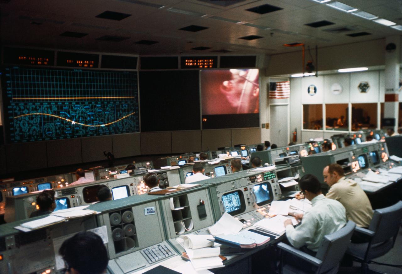 S69-59525 (19 Nov. 1969) --- Overall view of activity in the Mission Operations Control Room (MOCR) in the Mission Control Center (MCC), Building 30, during the Apollo 12 lunar landing mission. When this picture was made the first Apollo 12 extravehicular activity (EVA) was being televised from the surface of the moon.  Photo credit: NASA