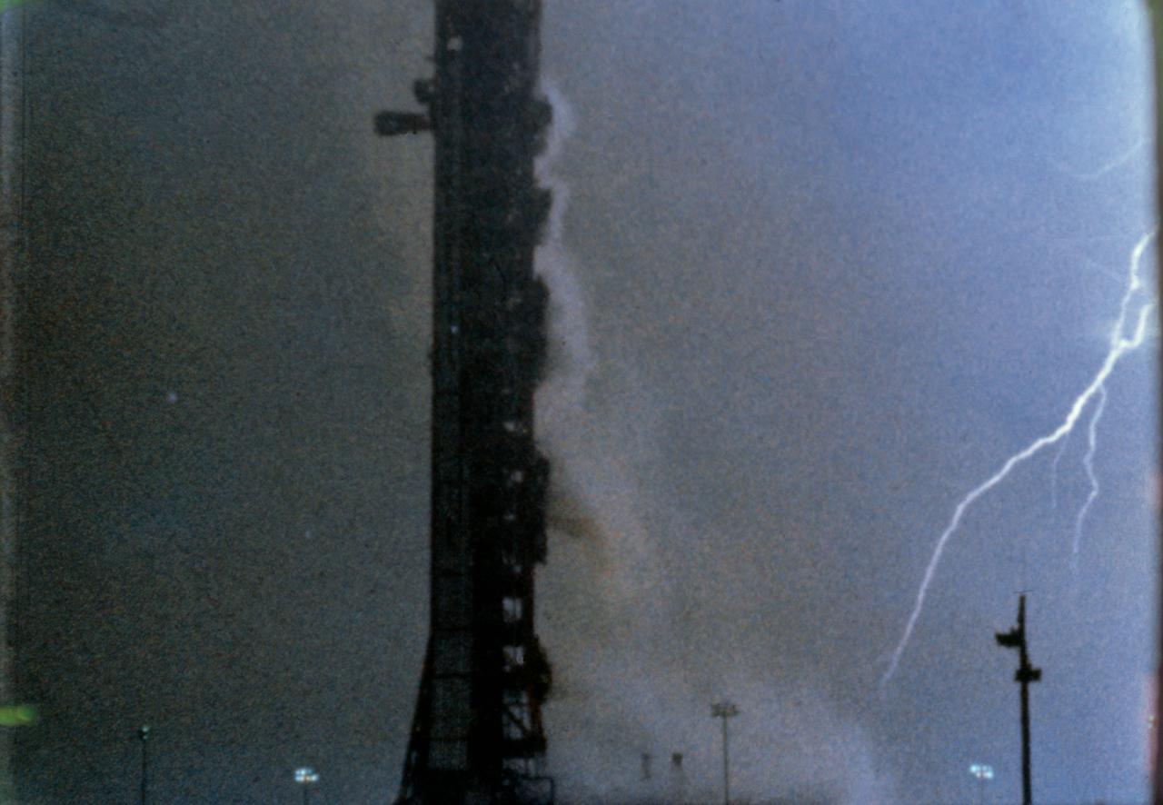 View of lightning striking near Pod 39A during the launch of Apollo XII from 16mm film.     1.  APOLLO XII - LAUNCH (LIGHTNING)      KENNEDY SPACE CENTER, FL