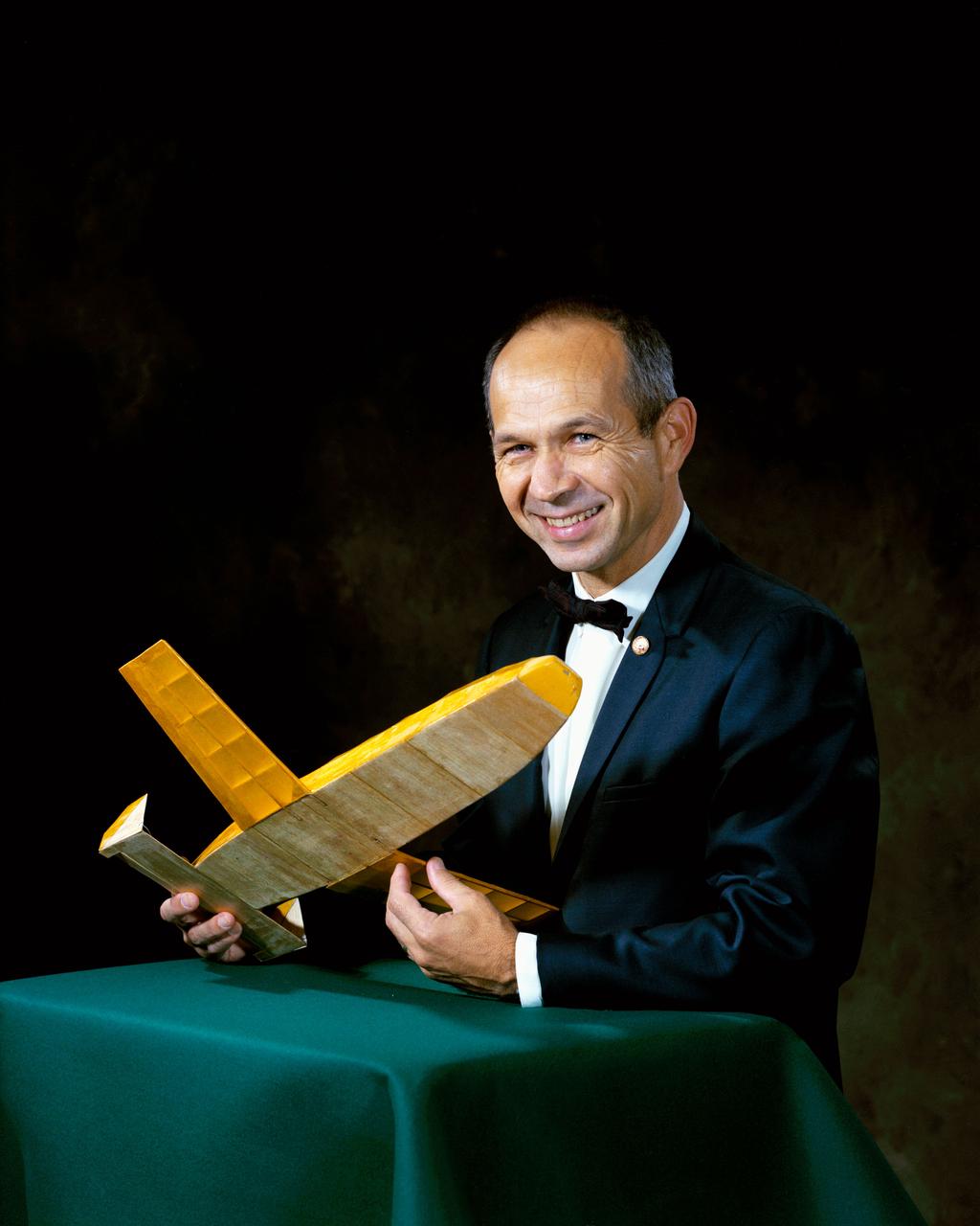 S69-64137 (1969) --- Maxime A. Faget,  Director of Engineering and Development, Manned Spacecraft Center, Houston, Texas, holds a model of an early space shuttle vehicle. Photo credit: NASA