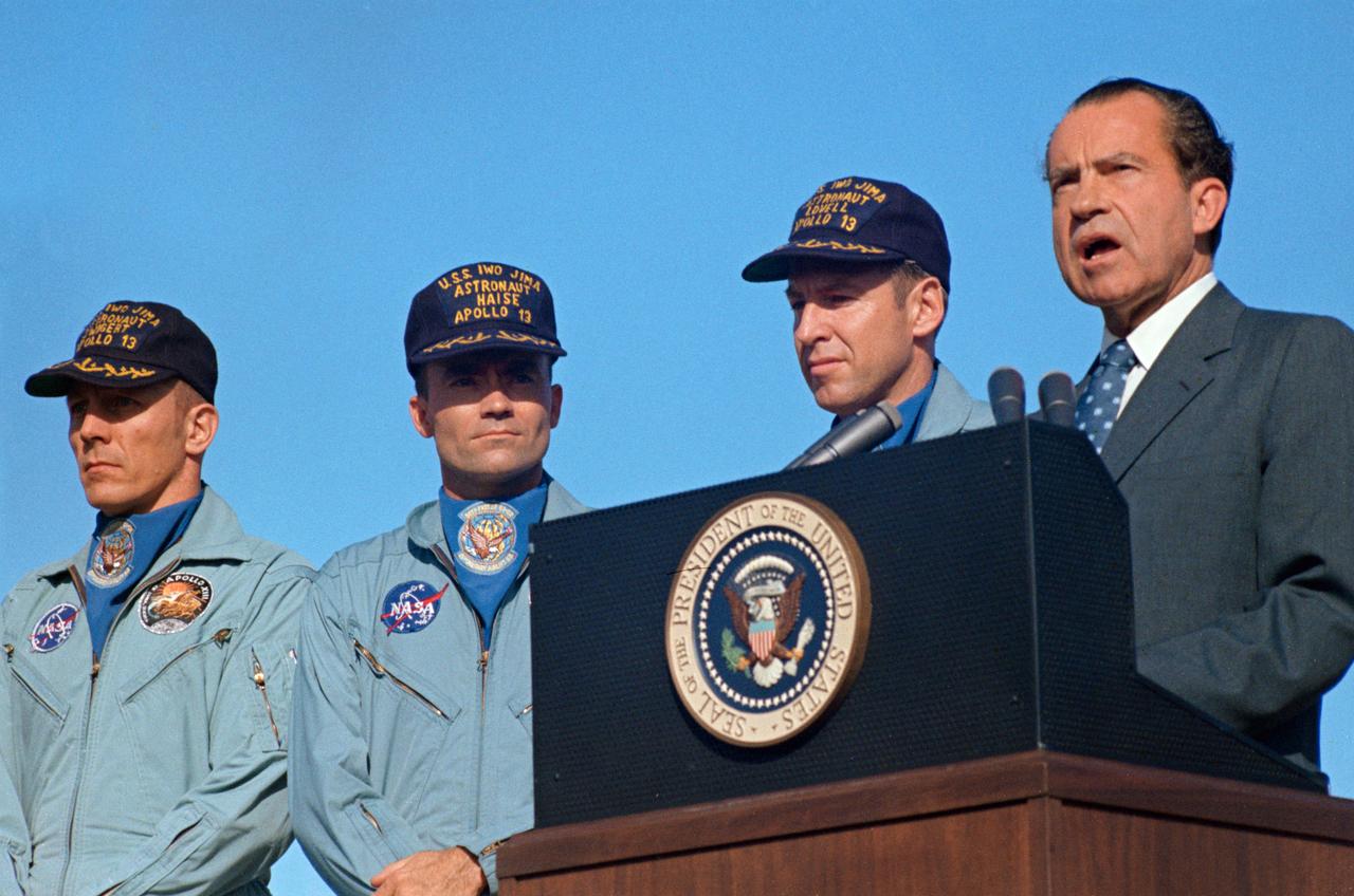 S70-15511 (19 April 1970) --- President Richard M. Nixon speaks at Hickham Air Force Base prior to presenting the nation's highest civilian award to the Apollo 13 crew.  Receiving the Presidential Medal of Freedom were astronauts James A. Lovell Jr., (next to the Chief Executive), commander; John L. Swigert Jr. (left), command module pilot; and Fred W. Haise Jr., lunar module pilot.  Wives of Lovell and Haise and the parents of Swigert accompanied the President to Hawaii. The Apollo 13 splashdown occurred at 12:07:44 p.m. (CST), April 17, 1970, about a day and a half prior to the Hickam Air Force Base ceremonies.