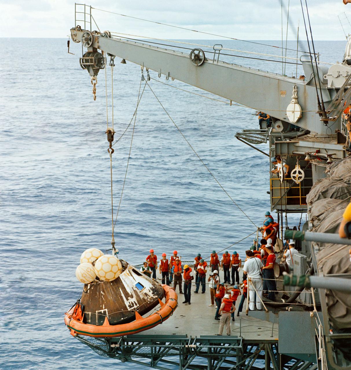 S70-15530 (17 April 1970) --- Crew men aboard the USS Iwo Jima, prime recovery ship for the Apollo 13 mission, hoist the Command Module (CM) aboard ship.  The Apollo 13 crew men, astronauts James A. Lovell Jr., John L. Swigert Jr. and Fred W. Haise Jr., were already aboard the Iwo Jima when this photograph was taken.  The CM, with the three tired crew men aboard, splashed down at 12:07:44 p.m. (CST), April 17, 1970, only about four miles from the recovery vessel in the South Pacific Ocean.