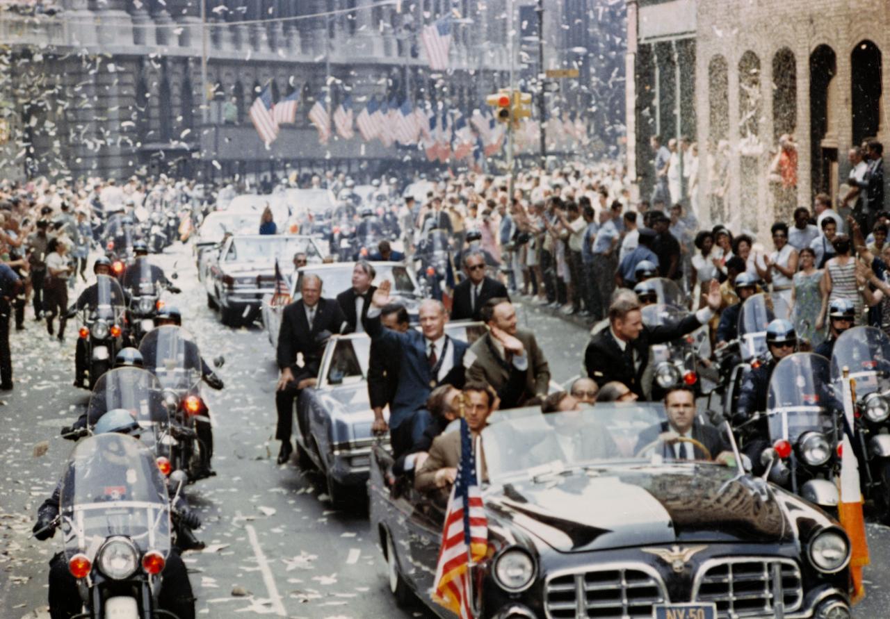 S70-17433 (13 Aug. 1969) --- New York City welcomes Apollo 11 crewmen in a showering of ticker tape down Broadway and Park Avenue in a parade termed as the largest in the city's history. Pictured in the lead car, from the right, are astronauts Neil A. Armstrong, commander; Michael Collins, command module pilot; and Edwin E. Aldrin Jr., lunar module pilot. The three astronauts teamed for the first manned lunar landing, on July 20, 1969.
