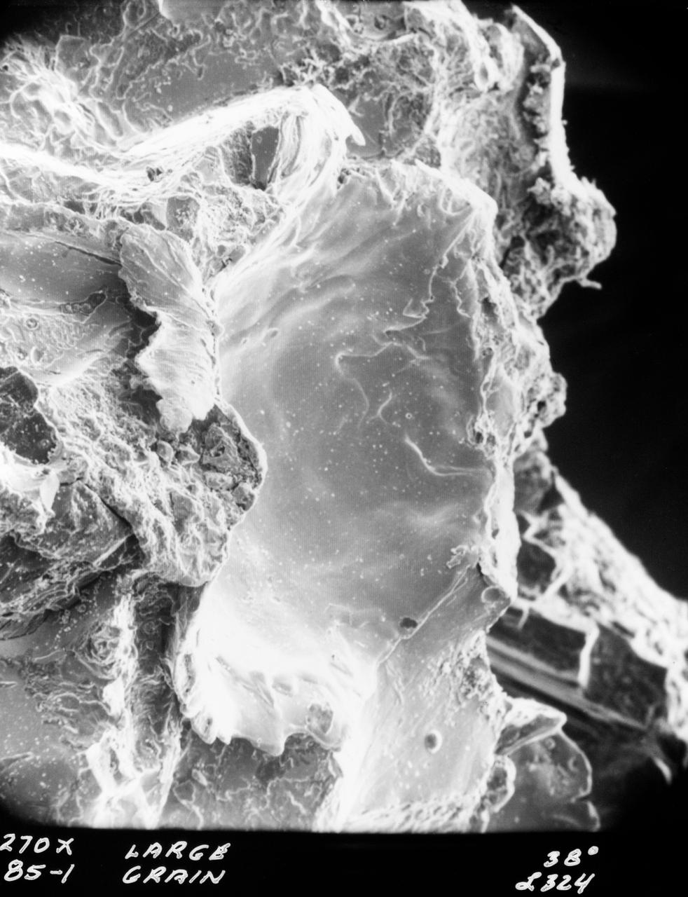 S70-20416 (December 1969) --- Enlarged view show hypervelocity impact on iron particles of lunar surface material returned to Earth by the crew of the Apollo 11 lunar landing mission. This photograph, enlarged to 270 times the actual size, was taken by Dr. G. J. Wasserberg, J. DeVaney and K. Evans at the California Institute of Technology.