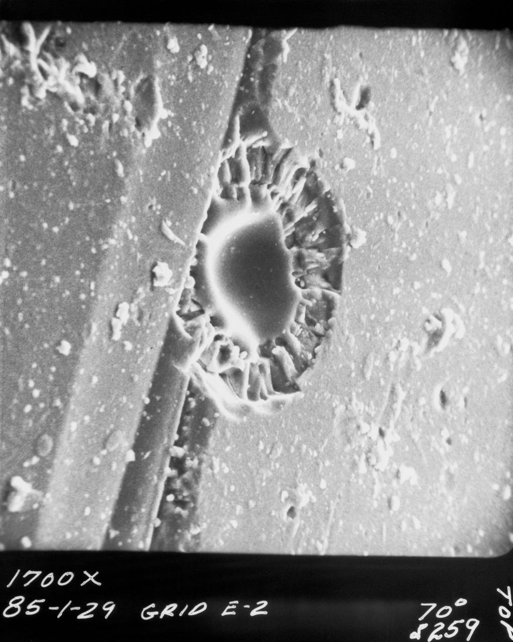 S70-20418 (December 1969) --- Enlarged view shows cosmic dust on broken glass particles, photographed by Dr. G. J. Wasserberg, J. DeVaney and K. Evans at California Institute of Technology during examination of the Apollo 11 lunar material. The photograph was enlarged to 1,700 time its actual size.