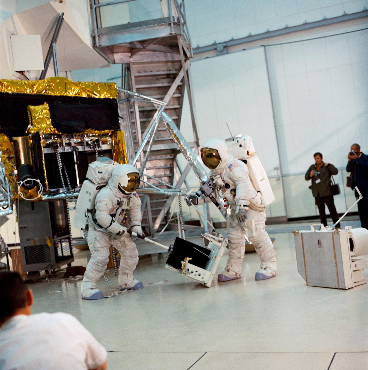 S70-27036 (4 Feb. 1970) --- Two crew men of the Apollo 13 lunar landing mission simulate lunar surface extravehicular activity (EVA) during training exercises in the Kennedy Space Center's (KSC) Flight Crew Training Building.  They are astronauts James A. Lovell Jr. commander; and Fred W. Haise Jr., lunar module pilot.