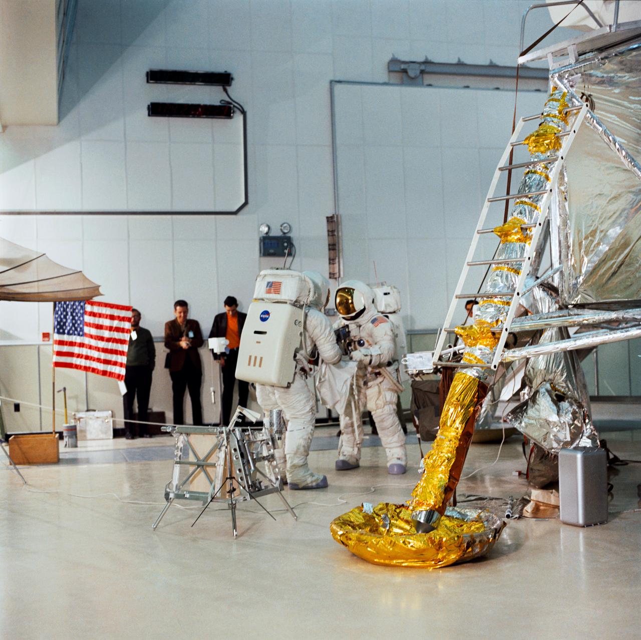 S70-27038 (4 Feb. 1970) --- Two crew men of the Apollo 13 lunar landing mission simulate lunar surface Extravehicular Activity (EVA) during training exercises in the Kennedy Space Center's (KSC) Flight Crew Training Building.  They are astronauts James A. Lovell Jr. (on left, back to camera) commander; and Fred W. Haise Jr., lunar module pilot.