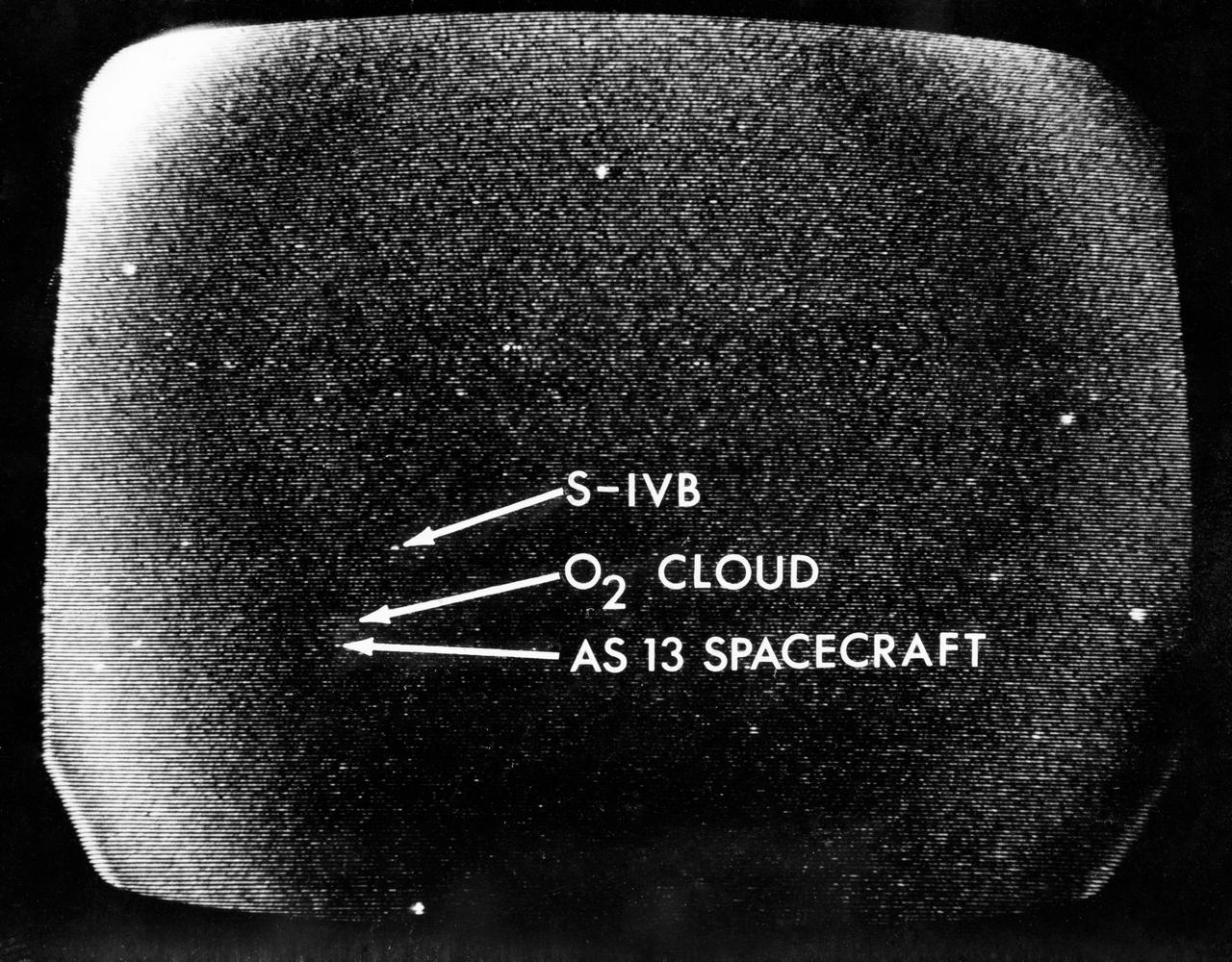 S70-34857 (13 April 1970) --- A telescopic photograph showing the Apollo 13 spacecraft in trans-lunar trajectory in the distant sky.  Arrows point to the spacecraft, to the oxygen cloud, and to the expended Saturn V third stage. Apollo 13 was tracked at the Manned Spacecraft Center (MSC) using a 16 inch Schmidt-Cassegrain telescope with an IO television camera with an S-20 type IO tube, mounted in place of the eyepiece.  The TV camera information is stored first on a data disc and played back on a viewing monitor from which this photograph was taken.