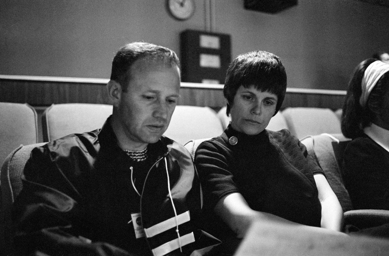 S70-34900 (14 April 1970) --- Mrs. Mary Haise receives an explanation of the revised flight plan of the Apollo 13 mission from astronaut Gerald P. Carr in the viewing room of the Mission Control Center (MCC), Building 30, at the Manned Spacecraft Center (MSC).  Her husband, astronaut Fred W. Haise Jr., lunar module pilot for the Apollo 13 mission, was joining fellow crew members, astronauts James A. Lovell Jr., and John L. Swigert Jr. in making correction in their spacecraft following discovery of an oxygen cell failure several hours earlier.