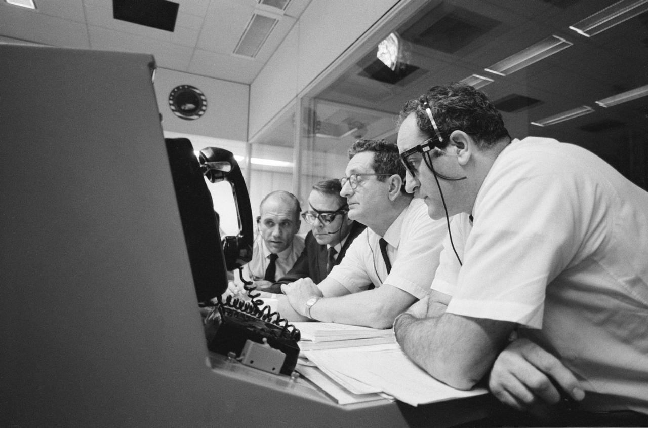 S70-35096 (16 April 1970) --- As the problem-plagued Apollo 13 crewmen entered their final 24 hours in space, several persons important to the mission remained attentive at consoles in the Mission Operations Control Room of the Mission Control Center at Manned Spacecraft Center.  Among those monitoring communications and serving in supervisory capacities were these four officials from National Aeronautics and Space Administration Headquarters, Washington, D.C.: (from left) Thomas H. McMullen, Office of Manned Space Flight, who served as Shift 1 mission director; Dale Myers, associate administrator, Manned Space Flight; Chester M. Lee of the Apollo Program Directorate, OMSF, Apollo 13 mission director; and Dr. Rocco A. Petrone, Apollo program director, OMSF.