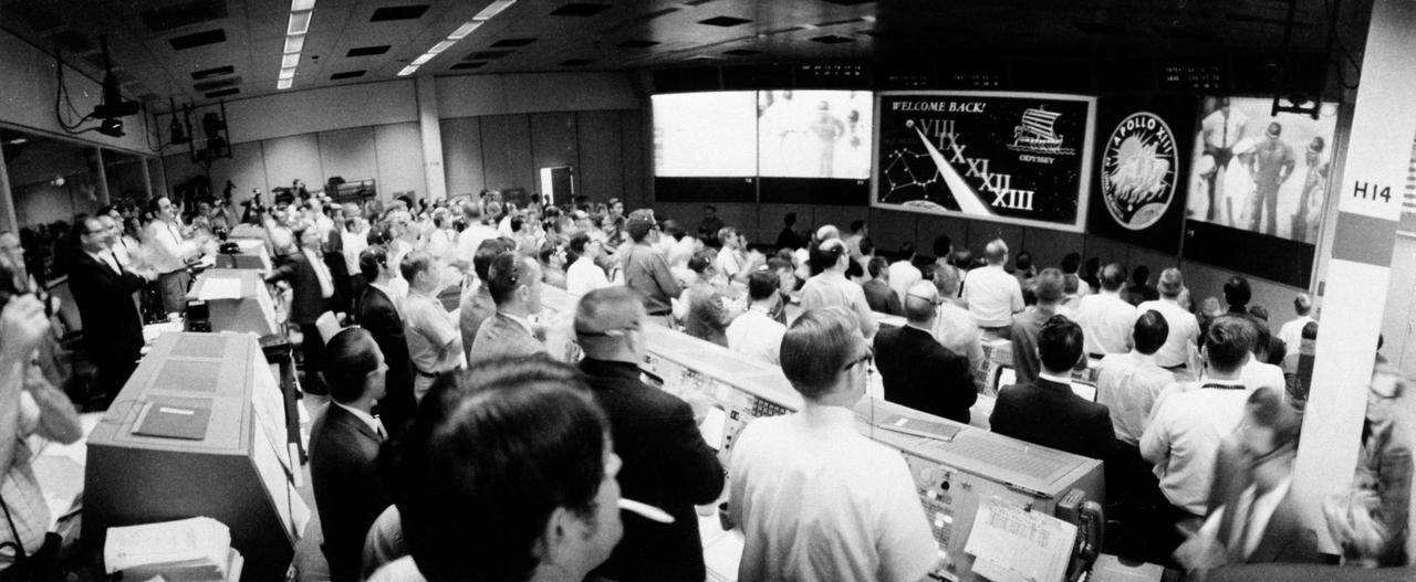 S70-35472 (17 April 1970) --- Overall view of the crowded Mission Operations Control Room (MOCR) in the Mission Control Center (MCC) at the Manned Spacecraft Center (MSC) during post-recovery ceremonies aboard the USS Iwo Jima, prime recovery ship for the Apollo 13 mission.  The Apollo 13 spacecraft, with astronauts James A. Lovell Jr., commander; John L. Swigert Jr., command module pilot; and Fred W. Haise Jr., lunar module pilot, aboard, splashed down in the South Pacific at 12:07:44 p.m. (CST), April 17, 1970.  The smooth splashdown and recovery operations brought an end to a perilous spaceflight for the crewmembers, and a tiring one for ground crew in MCC.