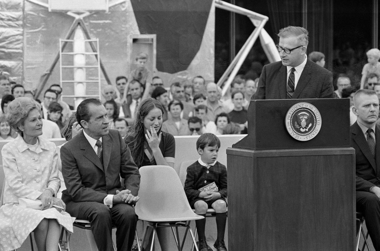 S70-35595 (18 April 1970) --- President Richard M. Nixon is welcomed to Manned Spacecraft Center (MSC) and introduced by Dr. Thomas O. Paine, Administrator, National Aeronautics and Space Administration (NASA). The First Lady is at extreme left. Others on the speakers platform in this view are Barbara and Jeffrey C. Lovell, children of astronaut James A. Lovell Jr., commander; and Eugene F. Kranz (extreme right), one of four flight directors on duty around the clock during the mission. President Nixon was on the site to present the Presidential Medal of Freedom to the Apollo 13 Mission Operations Team.