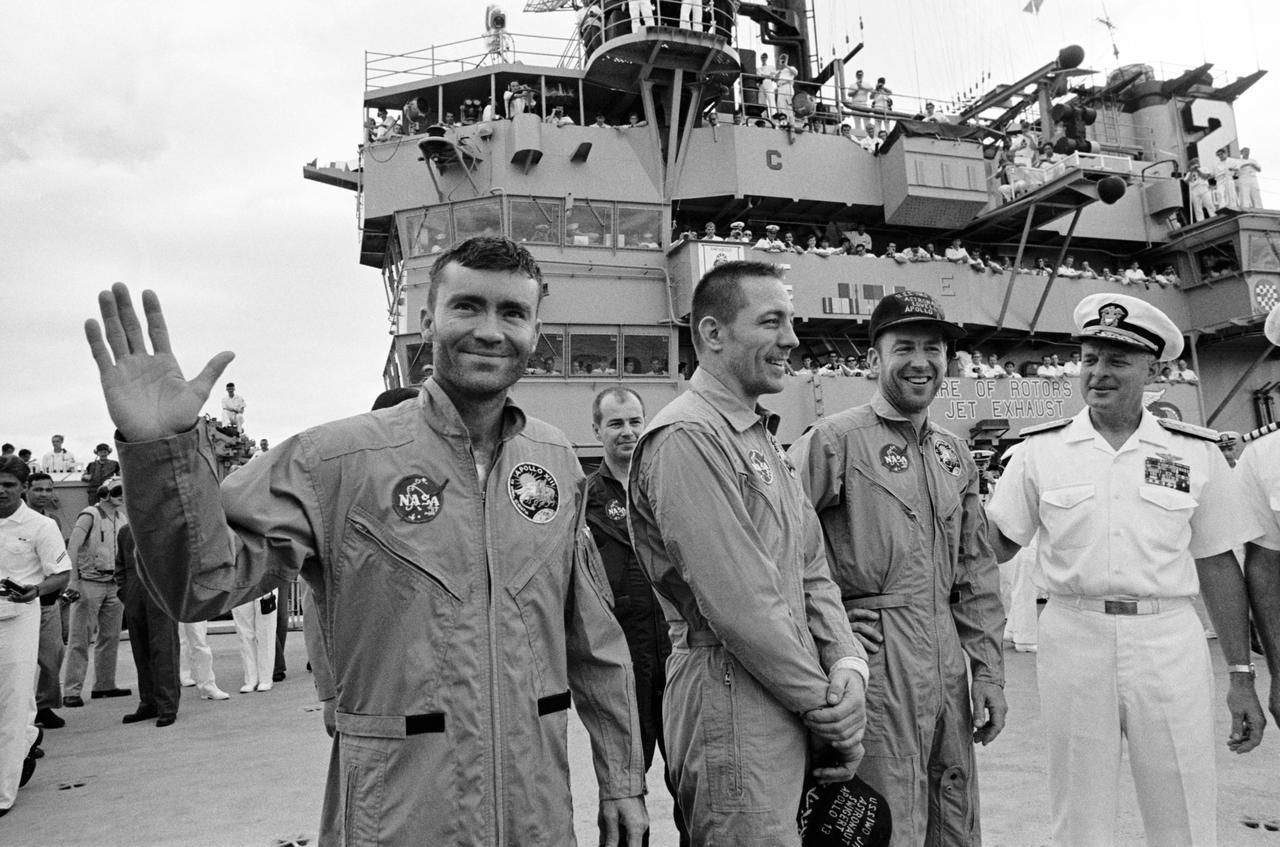 S70-35606 (17 April 1970) --- Rear Admiral Donald C. Davis, Commanding Officer of Task Force 130, the Pacific Recovery Forces for the Manned Spacecraft Missions, welcomes the Apollo 13 crewmembers aboard the USS Iwo Jima, prime recovery ship for the Apollo 13 mission. The crewmembers (from the left) astronauts Fred W. Haise Jr. (waving), lunar module pilot; John L. Swigert Jr., command module pilot; and James A. Lovell Jr., commander; were transported by helicopter to the ship following a smooth splashdown only about four miles from the USS Iwo Jima. Splashdown occurred at 12:07:44 p.m. (CST), April 17, 1970, to conclude safely a perilous space flight.