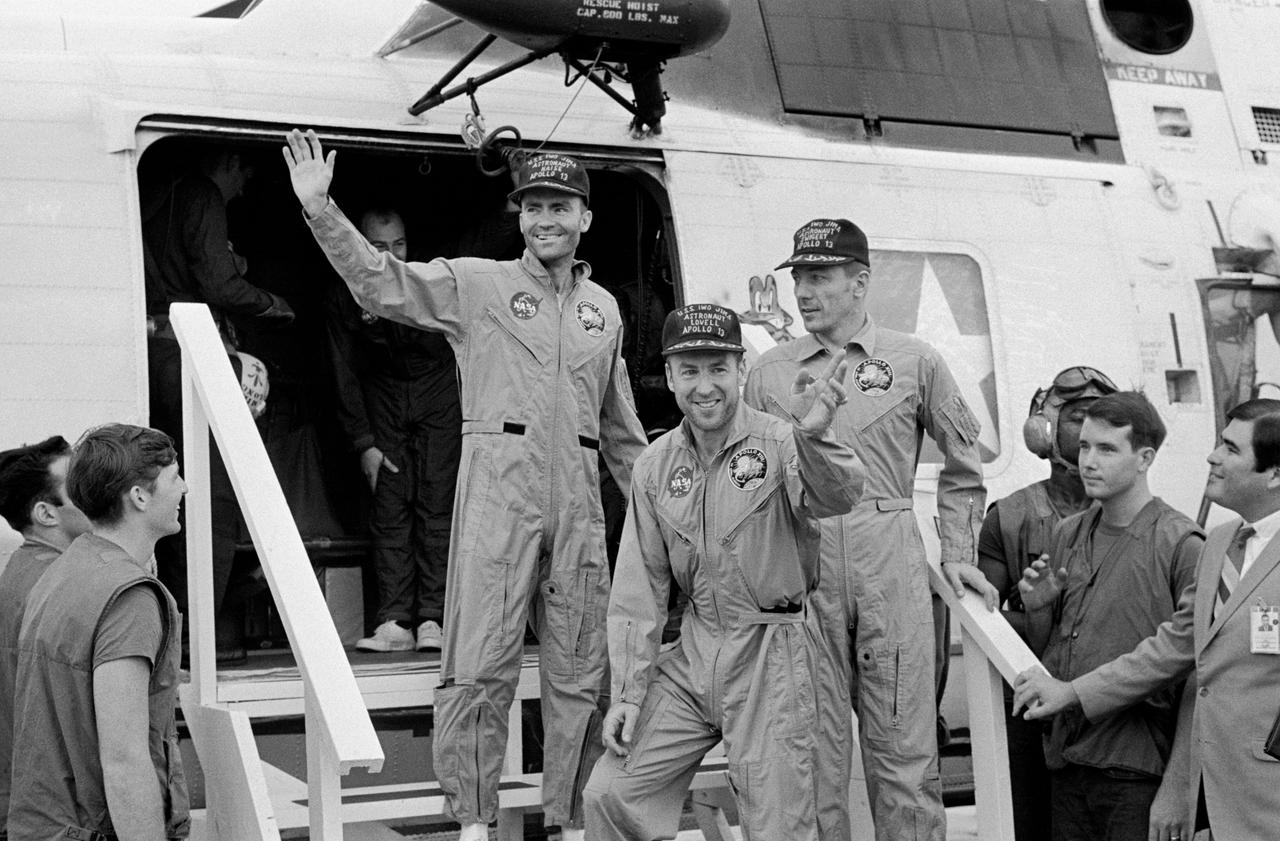 S70-35614 (17 April 1970) --- The crewmembers of the Apollo 13 mission, step aboard the USS Iwo Jima, prime recovery ship for the mission, following splashdown and recovery operations in the South Pacific Ocean. Exiting the helicopter which made the pick-up some four miles from the Iwo Jima are (from left) astronauts Fred W. Haise Jr., lunar module pilot; James A. Lovell Jr., commander; and John L. Swigert Jr., command module pilot.  The crippled Apollo 13 spacecraft splashed down at 12:07:44 p.m. (CST), April 17, 1970.