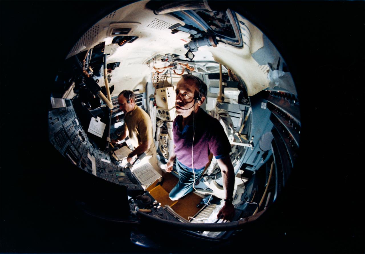 S70-45555 (July 1970) --- A fish-eye lens view showing astronauts Alan B. Shepard Jr. (foreground) and Edgar D. Mitchell in the Apollo lunar module mission simulator at the Kennedy Space Center during preflight training for the Apollo 14 lunar landing mission. Shepard is the Apollo 14 commander; and Mitchell is the lunar module pilot.