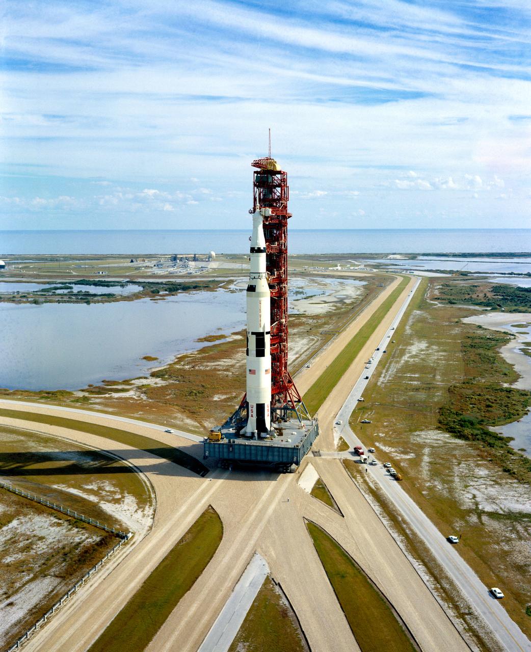 S70-54119 (9 Nov. 1970) --- A high-angle view at Launch Complex 39, Kennedy Space Center (KSC), showing the Apollo 14 (Spacecraft 110/Lunar Module 8/Saturn 509) space vehicle on the way from the Vehicle Assembly Building (VAB) to Pad A. The Saturn V stack and its mobile launch tower sit atop a huge crawler-transporter. The Apollo 14 crewmen will be astronauts Alan B. Shepard Jr., commander; Stuart A. Roosa, command module pilot; and Edgar D. Mitchell, lunar module pilot.