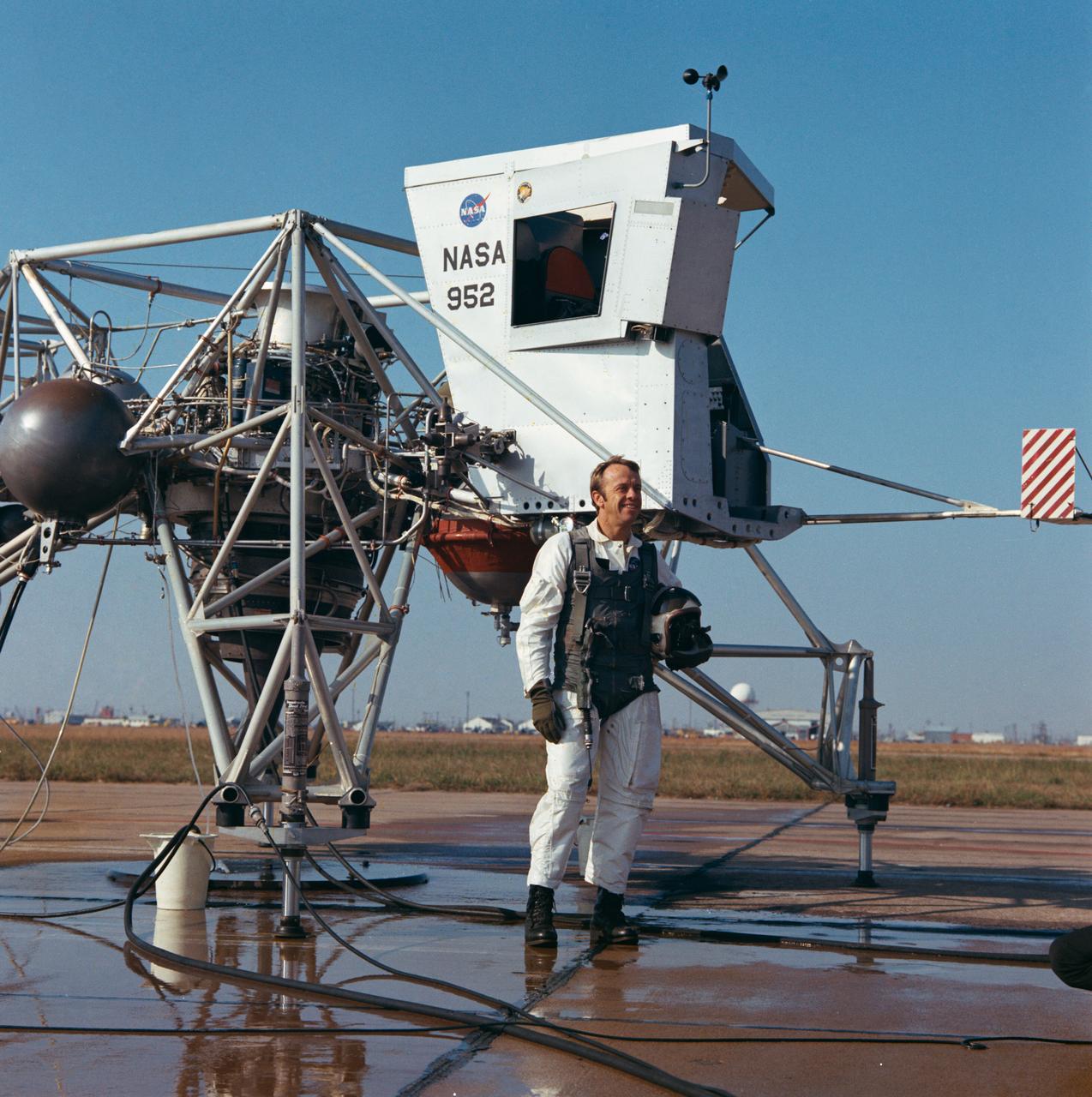 S70-56287 (14 Dec. 1970) --- Astronaut Alan B. Shepard Jr., commander of the Apollo 14 lunar landing mission, stands near a Lunar Landing Training Vehicle (LLTV) prior to a test flight at Ellington Air Force Base, Houston, on Dec. 14, 1970. Shepard will be at the controls of the Apollo 14 Lunar Module (LM) when it lands on the moon in the highlands near Fra Mauro. Astronaut Stuart A. Roosa, command module pilot, will remain with the Command and Service Modules (CSM) in lunar orbit while astronauts Shepard and Edgar D. Mitchell, lunar module pilot, descend in the LM to explore the moon.