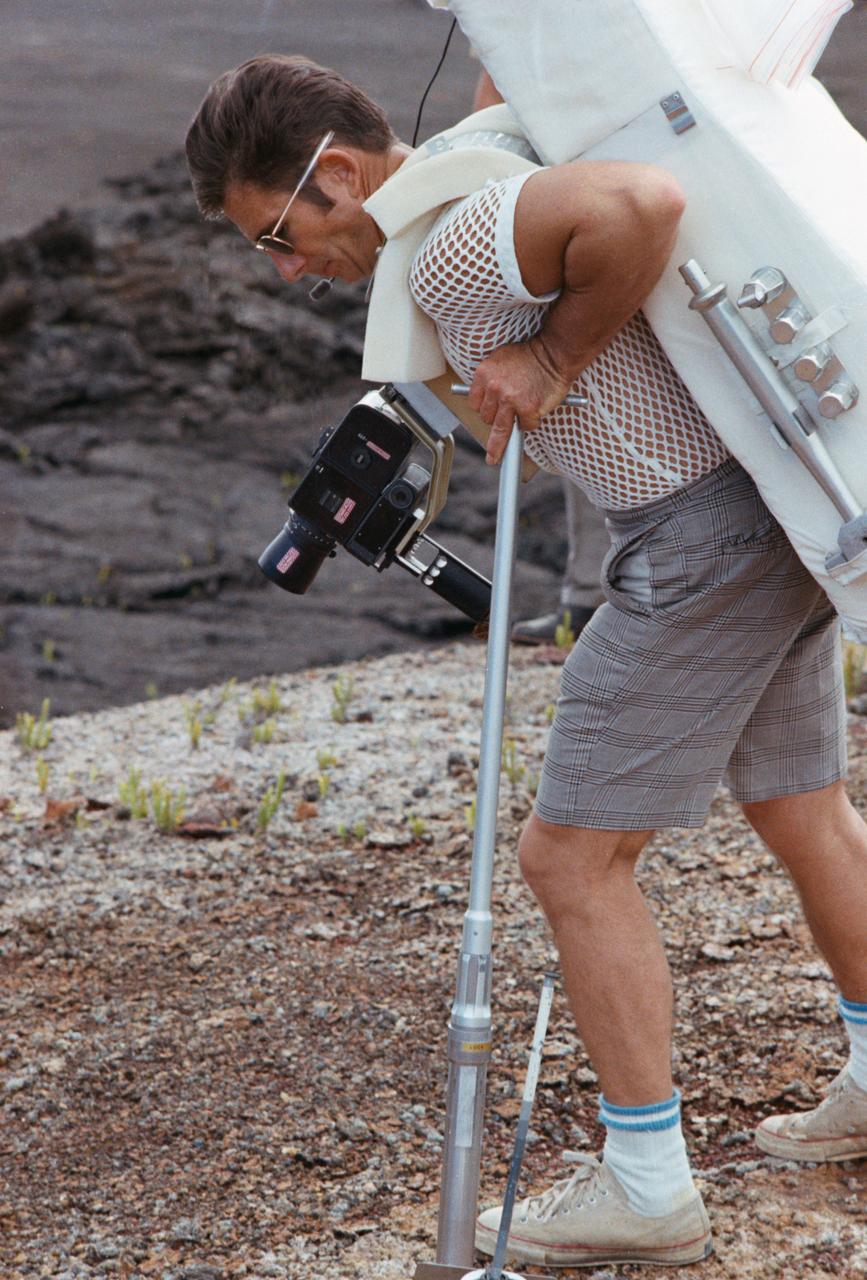 S70-56433 (December 1970) --- Astronaut James B. Irwin, lunar module pilot of the Apollo 15 lunar landing mission, participates in lunar surface extravehicular activity (EVA) training during a visit to Hawaii. He is simulating using lunar surface geological tools to collect a core sample.