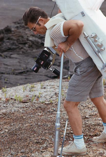 NASA image: Astronaut James Irwin simulates using lunar surface geological tools