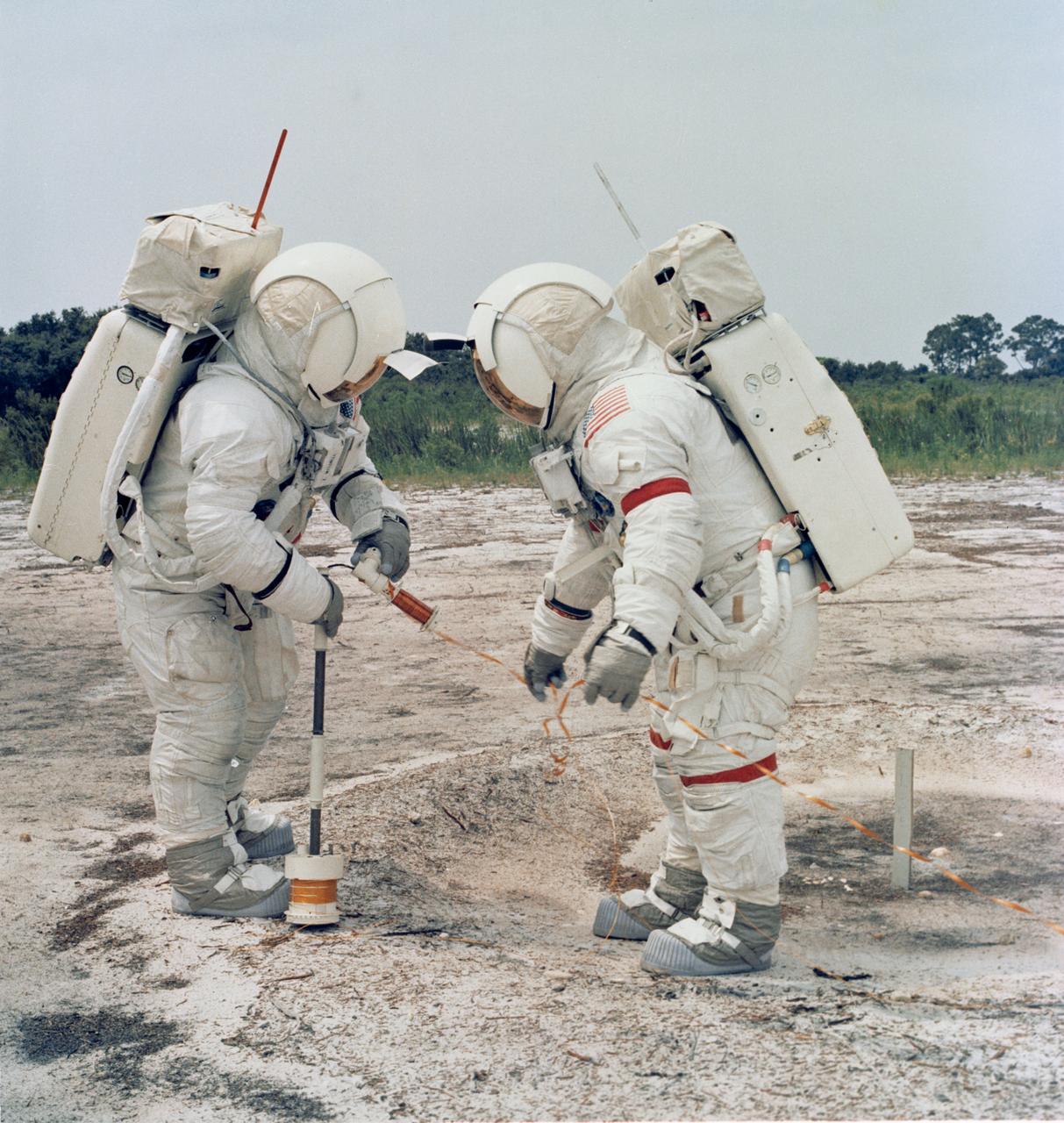 S71-15273 (October 1970) --- Apollo 14 astronauts Alan B. Shepard Jr., commander (right); and Edgar D. Mitchell, lunar module pilot, practice using the Active Seismic Experiment (ASE) to set off explosions on the lunar surface and arm a mortar to launch four grenades after they leave. Measurements of the ensuing vibrations of the moon, radioed to Earth, will give scientists new information on the shape, structure and thickness of the outer lunar crust. ASE will be deployed during one of two Apollo 14 extravehicular activity (EVA) periods.
