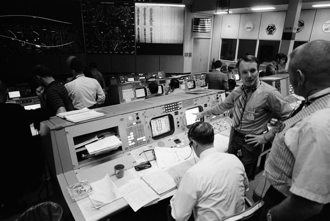S71-17610 (4 Feb. 1971) --- Partial view of activity in the Mission Operations Control Room in the Mission Control Center at the time the Apollo 14 S-IVB stage impacted on the lunar surface. The flight director's console is in the foreground. Eugene F. Kranz, chief of the MSC Flight Control Division, is in the right foreground. Seated at the console is Glynn S. Lunney, head of the Flight Director Office, Flight Control Division. Facing the camera is Gerald D. Griffin, flight director of the Third (Gold) Team. A seismic reading from the impact can be seen in the center background. The S-IVB impacted on the lunar surface at 1:40:54 a.m. (CST), Feb. 4, 1971, about 90 nautical miles south-southwest of the Apollo 12 passive seismometer. The energy release was comparable to 11 tons of TNT.
