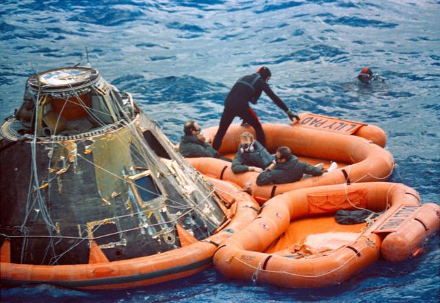 NASA image: Apollo 14 astronauts assisted out of Command Module by Navy divers