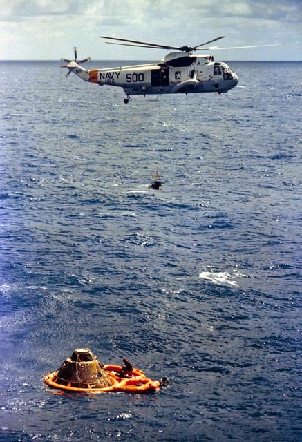 NASA image: Astronaut Stuart Roosa hoisted inside recovery net to Navy helicopter