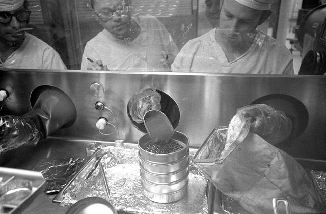 Technicians work with Apollo 14 lunar sample material in Lunar Receiving Lab.