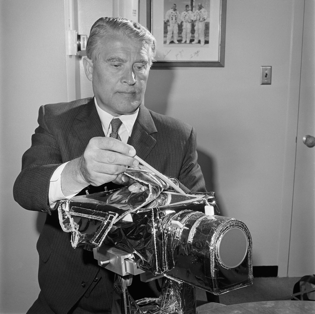 S71-35169 (June 1971) --- The color television camera for the National Aeronautics and Space Administration's (NASA) Apollo 15 lunar landing mission is examined by NASA's Deputy Associate Director Dr. Wernher von Braun. The camera will be mounted on the Lunar Roving Vehicle (LRV) and will be operated by the flight crew astronauts, David R. Scott and James B. Irwin, or by ground command from the Mission Control Center (MCC) in Houston during the three lunar traverses. It will also be used to show the astronauts whenever they leave the LRV, and for the first time it will make possible the viewing of the Lunar Module (LM) ascent stage as it lifts off the moon.