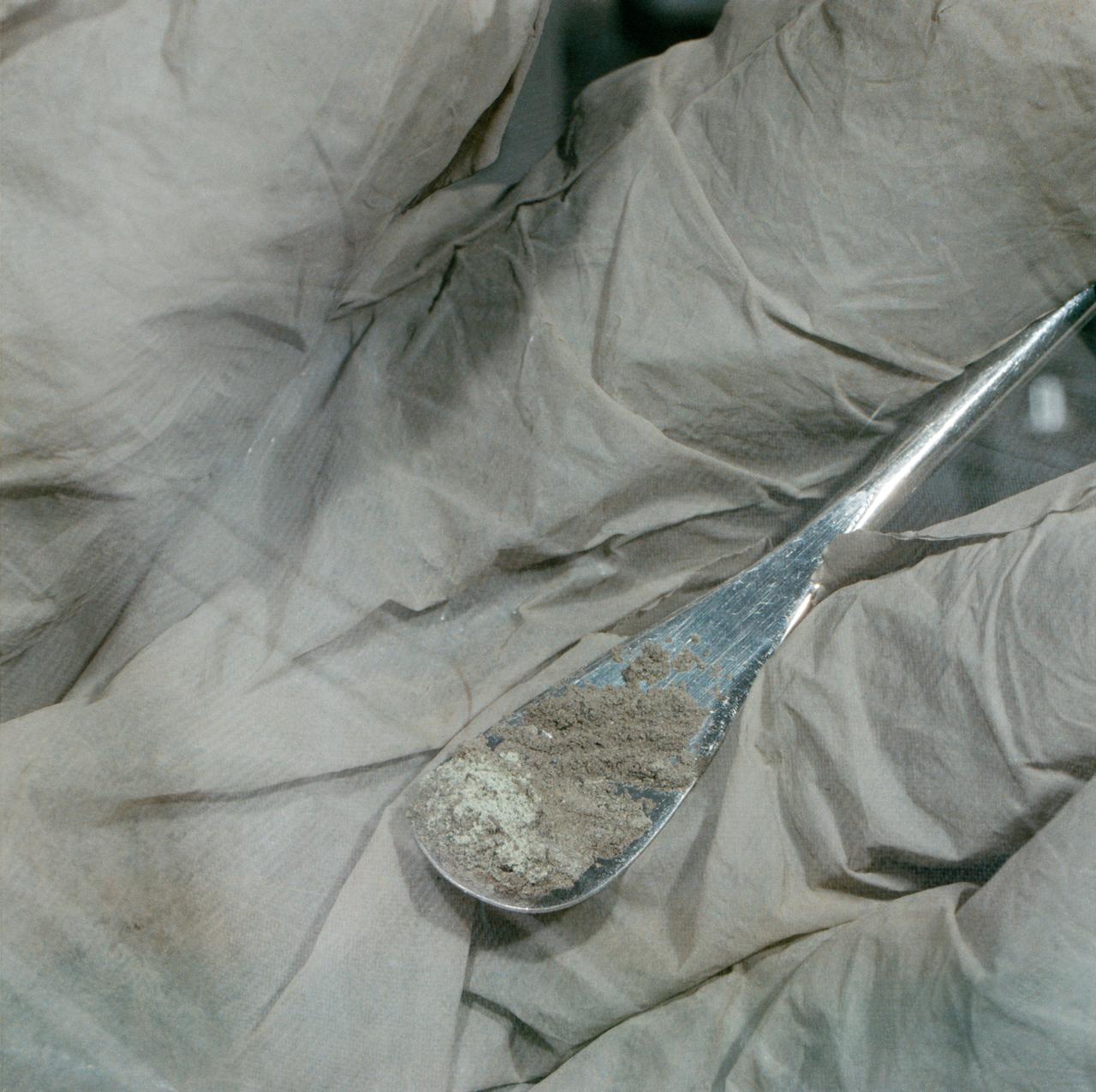 S71-43050 (August 1971) --- A close-up view of Apollo 15 lunar sample No. 15305 in the Non-sterile Nitrogen Processing Line (NNPL) in the Lunar Receiving Laboratory (LRL) at the Manned Spacecraft Center (MSC). This sample, pictured on a small spatula in a lab technician's glove, is green and is one of six recently taken from container No. 173, made up of comprehensive fines from the Apennine Front, Site No. 7. Astronauts David R. Scott, commander; and James B. Irwin, lunar module pilot, took the sample during their second extravehicular activity (EVA), at a ground elapsed time (GET) of 146:05 to 146:06.
