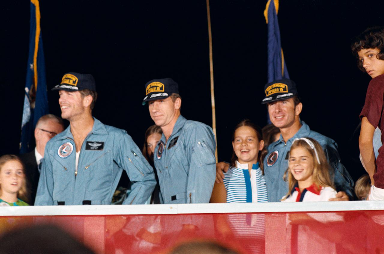 S71-43428 (8 Aug. 1971) --- The three crew men, of the highly successful Apollo 15 lunar landing mission, receive a warm welcome home at Ellington Air Force Base (EAFB), Houston, after an eight hour flight aboard a U.S. Air Force C-141 jet aircraft from Hawaii. Left to right, are astronauts David R. Scott, commander; Alfred M. Worden, command module pilot; and James B. Irwin, lunar module pilot. Apollo 15 splashdown in the mid-Pacific at 3:45 p.m. (CDT), Aug. 7, 1971, some 330 miles north of Honolulu. The C-141 landed at EAFB at 9 p.m. (CDT), Sunday, Aug. 8, 1971. Members of the astronauts' families identifiable in the picture are, left to right, Scott's daughter, Tracy; Worden's father, Merrill Worden; Worden's daughter, Merrill; and Irwin's two daughters, Joy and Jill.