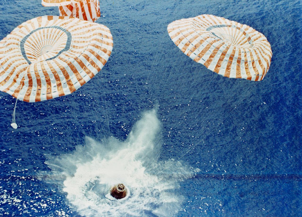 S71-43541 (7 Aug. 1971) --- The Apollo 15 Command Module (CM), with astronauts David R. Scott, commander; Alfred M. Worden, command module pilot; and James B. Irwin, lunar module pilot, aboard safely touches down in the mid-Pacific Ocean to conclude a highly successful lunar landing mission. Although causing no harm to the crew men, one of the three main parachutes failed to function properly. The splashdown occurred at 3:45:53 p.m. (CDT), Aug. 7, 1971, some 330 miles north of Honolulu, Hawaii. The three astronauts were picked up by helicopter and flown to the prime recovery ship, USS Okinawa, which was only 6 1/2 miles away.