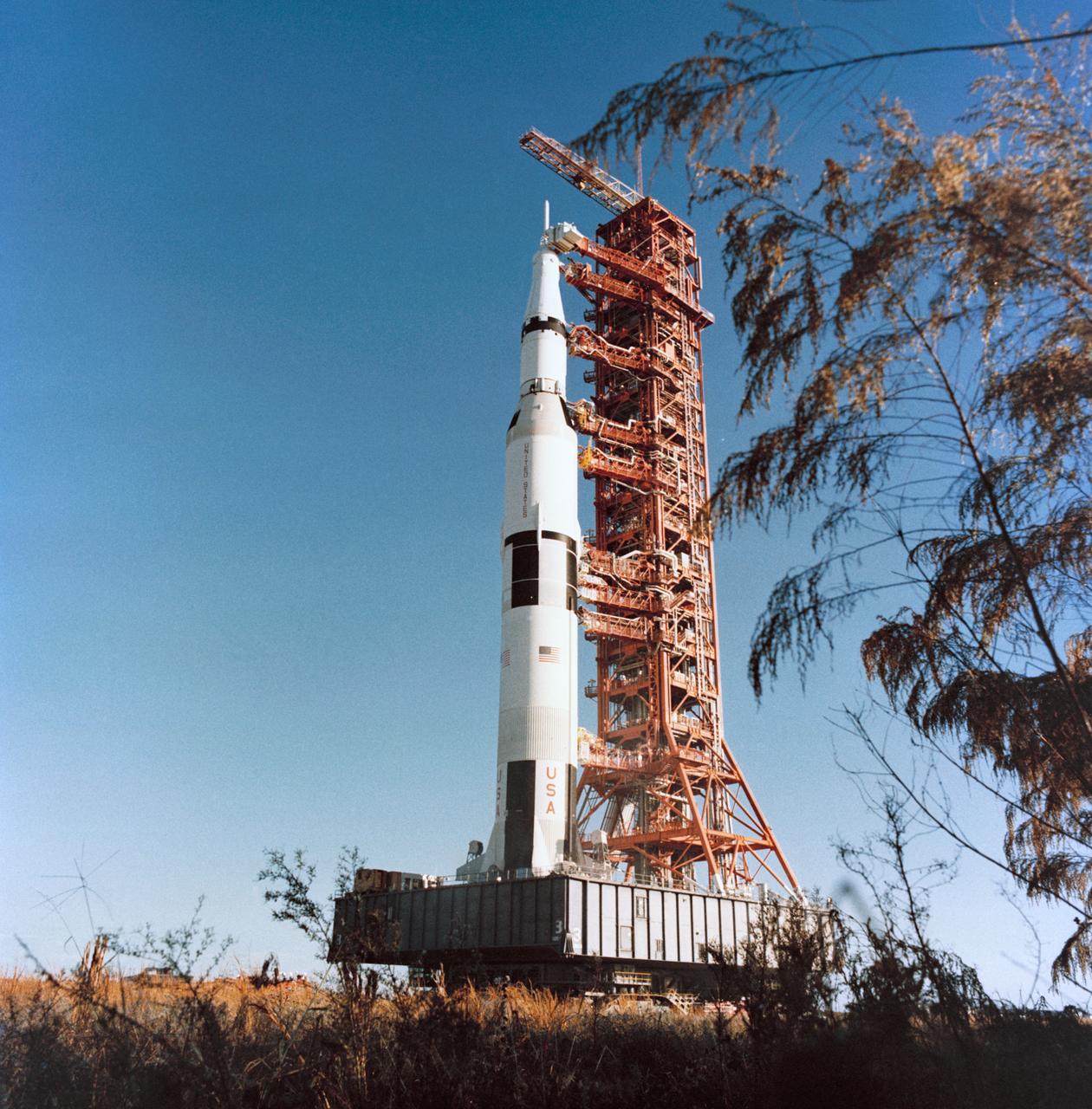 S72-19794 (13 Dec. 1971) --- A ground-level view showing the tall Apollo 16 (Spacecraft 113/Lunar Module 11/Saturn 511) space vehicle at the Kennedy Space Center's (KSC) Launch Complex 39 being moved from the Vehicle Assembly Building (VAB) toward Pad A. The Saturn V stack and its mobile launch tower are atop a huge crawler-transporter. The prime crew men of the scheduled Apollo 16 lunar landing mission are astronauts John W. Young, Apollo 16 lunar landing mission are astronauts John W. Young, commander; Thomas K. Mattingly II, command module pilot; and Charles M. Duke Jr., lunar module pilot.