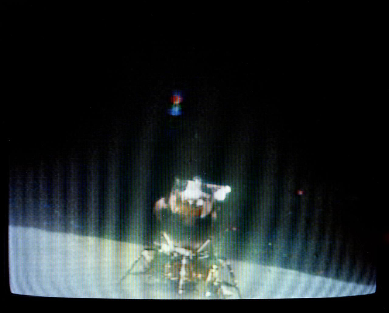 S72-35614 (23 April 1972) --- The Apollo 16 Lunar Module "Orion" ascent stage makes its liftoff from the lunar surface in this reproduction taken from a color television transmission made by the RCA color TV camera mounted on the Lunar Roving Vehicle (LRV). Remotely controlled from NASA's Mission Control Center (MCC) in Houston, the LRV-mounted camera made it possible for persons on Earth to watch the LM's launch from the moon. Liftoff occurred at 175:44 ground elapsed time, 7:26 p.m. (CST), April 23, 1972. The "Orion" ascent stage, with astronauts John W. Young and Charles M. Duke Jr. aboard, returned from the lunar surface to rejoin the Command and Service Modules (CSM) orbiting the moon. Astronaut Thomas K. (Ken) Mattingly II remained with the CSM in lunar orbit while Young and Duke descended in the LM to explore the Descartes landing site. The LM descent stage is used as a launching platform and remains behind on the moon.