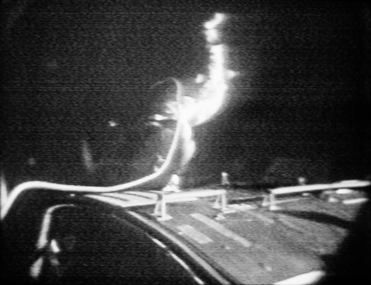 S72-35900 (25 April 1972) --- Astronaut Thomas K. (Ken) Mattingly II, command module pilot of the Apollo 16 lunar landing mission, floats in space outside the spacecraft during his trans-Earth extravehicular activity (EVA), as seen in this reproduction taken from a color television transmission made by a color TV camera mounted on the Command Module (CM) hatch. Mattingly used hand-holds and a foot restraint to hold himself in position, and he was secured to the spacecraft by an umbilical tether line. During his EVA, Mattingly made an inspection of the Service Module's (SM) Scientific Instrument Module (SIM) bay, and retrieved film cassettes from the Panoramic Camera and the Mapping Camera. The trans-Earth EVA occurred at ground elapsed time of 242:55, and 2:49 p.m. (CST), Tuesday, April 25, 1972.