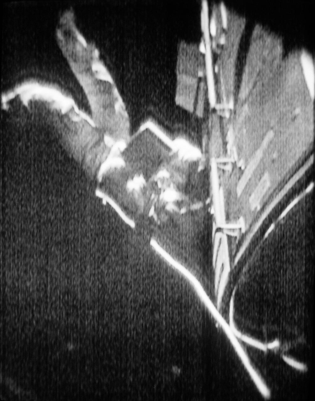 S72-35901 (25 April 1972) --- Astronaut Thomas K. (Ken) Mattingly II, command module pilot of the Apollo 16 lunar landing mission, floats in space outside the spacecraft during his trans-Earth extravehicular activity (EVA), as seen in this reproduction taken from a color television transmission made by a color TV camera mounted on the Command Module (CM) hatch. Mattingly used hand-holds and a foot restraint to hold himself in position, and he was secured to the spacecraft by an umbilical tether line. During his EVA, Mattingly made an inspection of the Service Module's (SM) Scientific Instrument Module (SIM) bay, and retrieved film cassettes from the Panoramic Camera and the Mapping Camera. The trans-Earth EVA occurred at ground elapsed time of 242:55, and 2:49 p.m. (CST), Tuesday, April 25, 1972.